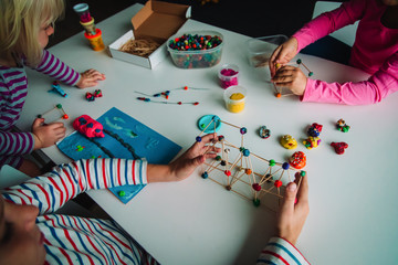 Wall Mural - kids making crafts from clay and sticks