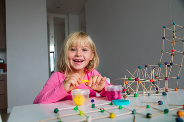 Wall Mural - cute girl making geometric shapes from clay, engineering and STEM