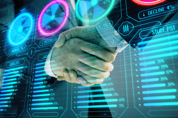 Multi exposure of business graph on abstract background with two men handshake. Concept of success