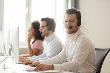 Wall Mural - millennial service phone operator sitting at workplace pose for camera