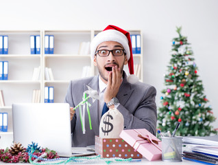 Young businessman celebrating christmas in the office