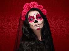 Portrait Of A Woman With Sugar Skull Makeup Over Red Background. Halloween Costume And Make-up. Portrait Of Calavera Catrina