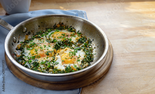 Cuadros en Lienzo pan with spinach and fried eggs, spices and herb garnish, protein-rich dish for