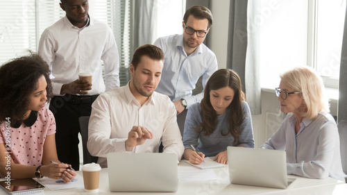 Cuadros en Lienzo Company employees listening boss sitting at desk in boardroom