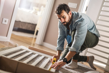 Assembling a wooden crib for baby