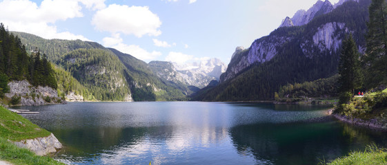  Lake, mountains with snow and forests in the region of Gosauseen, Austria. Panorama.