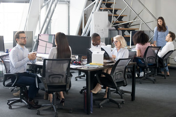 Wall Mural - Busy multi racial office employees working in coworking shared room