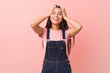 © Asier - Young pretty arab woman wearing a jeans dungaree laughs joyfully keeping hands on head. Happiness concept.