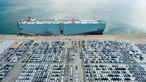 Aerial view cargo ship transportation of business logistic sea freight, New Cars produced by year up in the port for Cargo ship and Cargo import-export around in the world