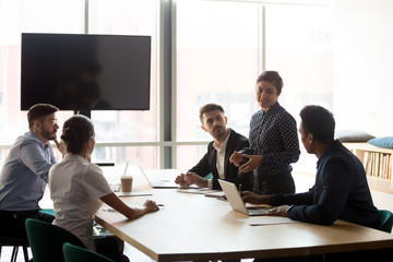 Poster - Confident female indian manager leading diverse employees group meeting