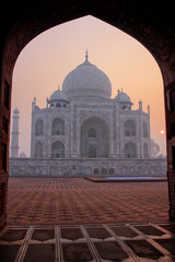 Wall Mural - Taj Mahal at sunrise framed with the arch of the mosque, Agra, Uttar Pradesh, India