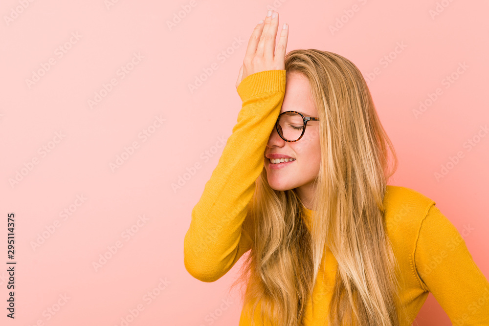 Adorable teenager woman forgetting something, slapping forehead with palm and closing eyes. - obrazy, fototapety, plakaty 