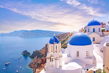 Beautiful Oia Town On Santorini Island, Greece. Traditional White Architecture  And Greek Orthodox Churches With Blue Domes Over The Caldera, Aegean Sea. Scenic Travel Background.
