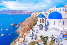 Beautiful Oia Town On Santorini Island, Greece. Traditional White Architecture  And Greek Orthodox Churches With Blue Domes Over The Caldera In Aegean Sea, Greece. Scenic Travel Background.