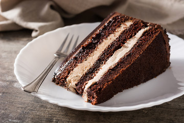 Chocolate cake slice on wooden table