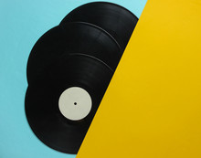 Halves Of Vinyl Records On Blue Yellow Background. Retro Music Albums, 70s. Top View