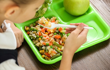 Wall Mural - Child with healthy food for school lunch at desk, closeup