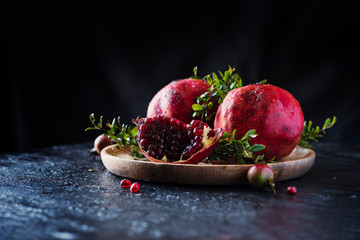 Sweet red pomegranate with green leaves