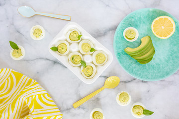 Wall Mural - Avocado Deviled Eggs on Blue Plate