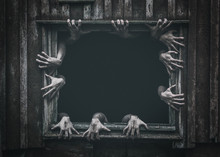 Hands Rising Out From The Old Window Ancient House, Halloween Concept. Increased Noise And Grain Effect.