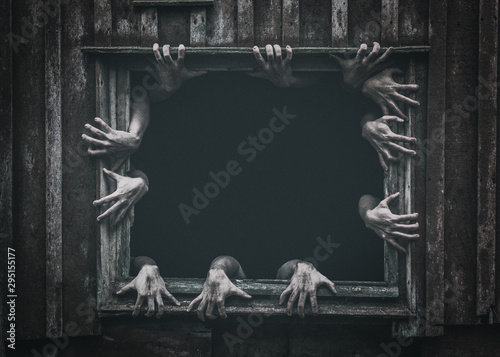 Fotografía Hands rising out from the old window ancient house, Halloween concept