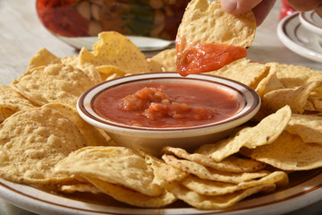 Canvas Print - Dipping a tortilla chip in salsa