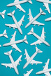 multitude of white aircraft on a blue background, concept of pollution by excessive air traffic