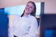 © as-artmedia - Security guard monitoring modern CCTV cameras in surveillance room. Female security guard in surveillance room. Smiling into camera.
