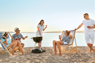 Canvas Print - Friends at barbecue party near river