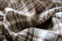 Folds Of A Brown White Checkered Geometric Tartan Cloth Pattern Texture, Closeup Macro View.