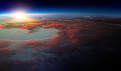 Wall Mural - Earth with sunrise on blue space background