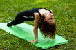 © Andrii Zastrozhnov - Woman practices yoga in morning in park in fresh air. Inverted Staff pose.