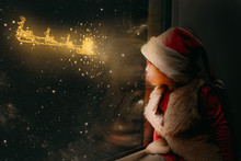 The Child Looks Out The Window On Christmas Day