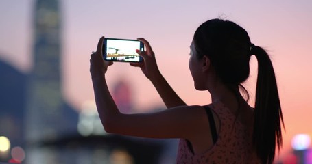 Poster - Woman take photo on cellphone in Hong Kong at night