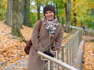 Beautiful brunette woman in autumn yellow park