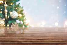 Christmas Tree Out Of Focus Background Over Brown Wooden Table