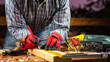© francescomou - Adult carpenter craftsman wears protective gloves, with a pencil and the carpenter's square trace the cutting line on a wooden table. Construction industry, housework do it yourself. Stock photography