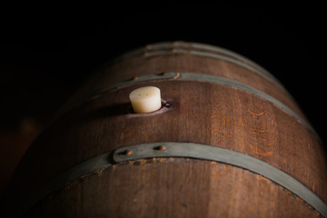 Wooden barrel in a dark cellar