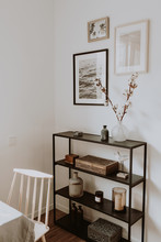 Modern Scandinavian Nordic Living Room With Beautiful Details Such As Black Shelves, Vases, Frames, Wooden Caskets, Cotton, Wooden Beige Chair, White Table. Scandi Design Interior Concept.