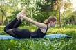 © Ravil Sayfullin - Beautiful woman doing Pilates in the green park