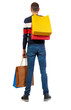© ghoststone - back view of man with shopping bags .