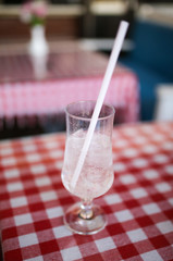 Wall Mural - A glass of cold water with ice on a table in a cafe