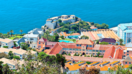 Aerial view of Gibraltar with modern buildings and the harbor with boats in the background in a sunny day