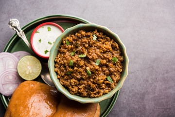 Wall Mural - Kheema / keema Pav or Khima Paav is a spicy curry dish made up of minced chicken or lamb cooked with onion, tomatoes, served with buns. selective focus