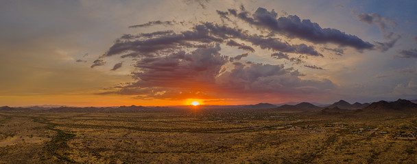 Wall Mural - A panorama of a sunset over the Sonoran Desert take by a drone with lots of colorful clouds on the horizon