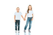 © LIGHTFIELD STUDIOS - cute kids holding hands and standing in blue jeans on white