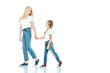 © LIGHTFIELD STUDIOS - happy mother holding hands with kid and walking on white
