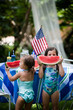 © Kinzie+Riehm - Kids Eating watermelon in their yard on the fourth of July