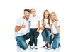 © LIGHTFIELD STUDIOS - happy parents and kids showing thumbs up on white