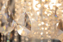 Luxury Hanging Crystal Chandelier Shiny Decoration Interior , Blur Bokeh Light Lamp At Background . Beautiful Electricity Expensive Furniture .